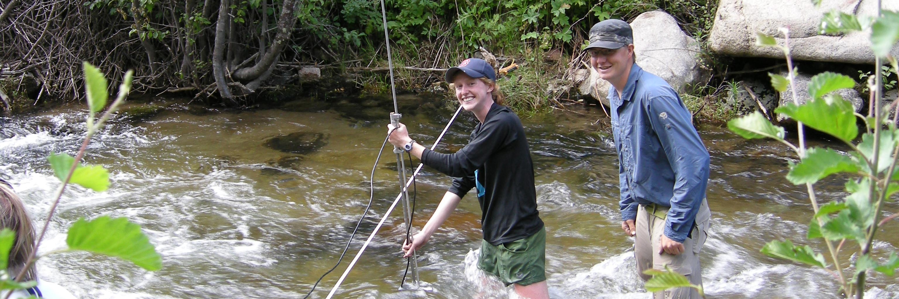 Students performing fieldwork in a stream