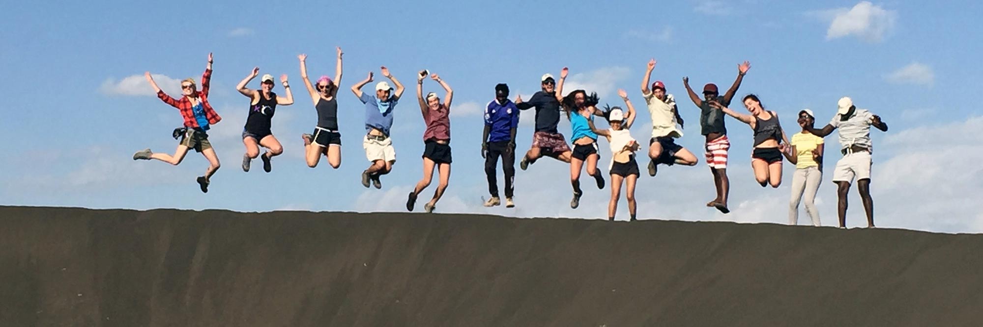 Line of research students jumping for joy