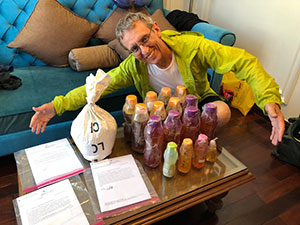 Arndt Schimmelmann shows bottles of tropical honey, oils and rice on a table