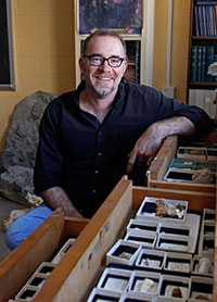 David Polly sits next to research findings